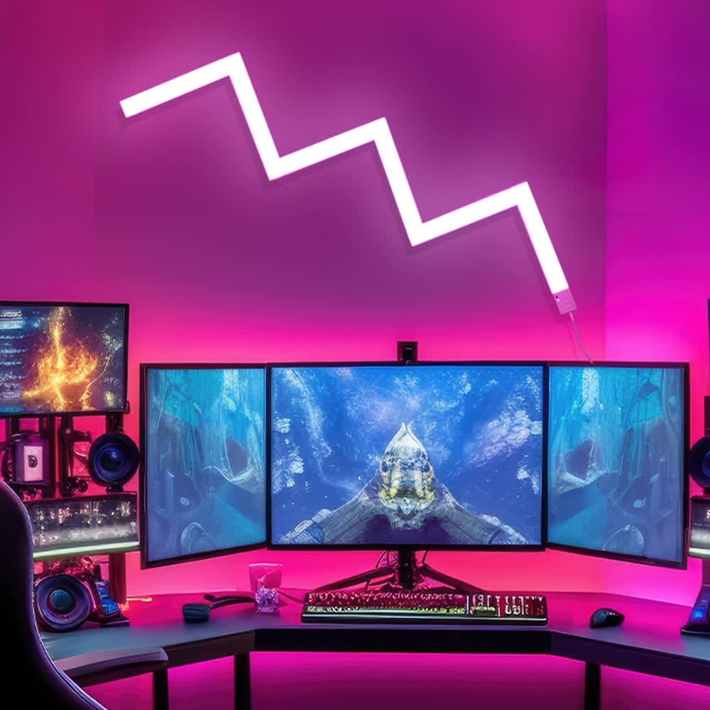 Triple-monitor gaming setup with pink LED wall lighting, a zigzag wall light feature, and RGB keyboard on a sleek corner desk.