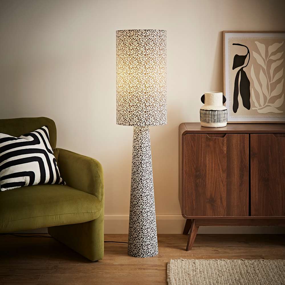 A leopard print fabric floor lamp in a colourful living room set up
