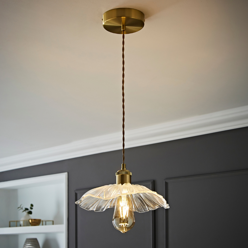 Glass petal pendant light with a warm bulb, gold ceiling fitting and colour matched braided fabric cable.