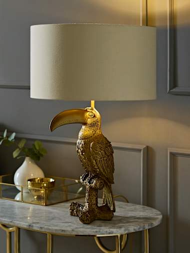 Brushed Bronze Toucan Table Lamp with Beige and Gold Drum Shade